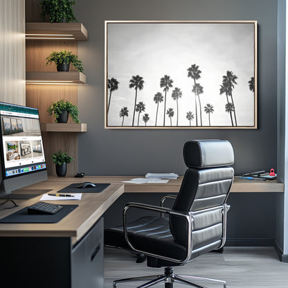A black and white minimalist scene featuring tall palm trees silhouetted against a bright sky, creating a dreamy and timeless tropical aesthetic.