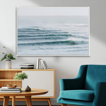 High-angle view of surfers lining up across layered ocean waves, ideal for minimal coastal or surf-inspired room decor.