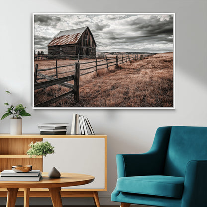 Framed canvas of a rustic barn under a moody sky with weathered fence and dark fields, ideal for farmhouse or rural-style wall decor.