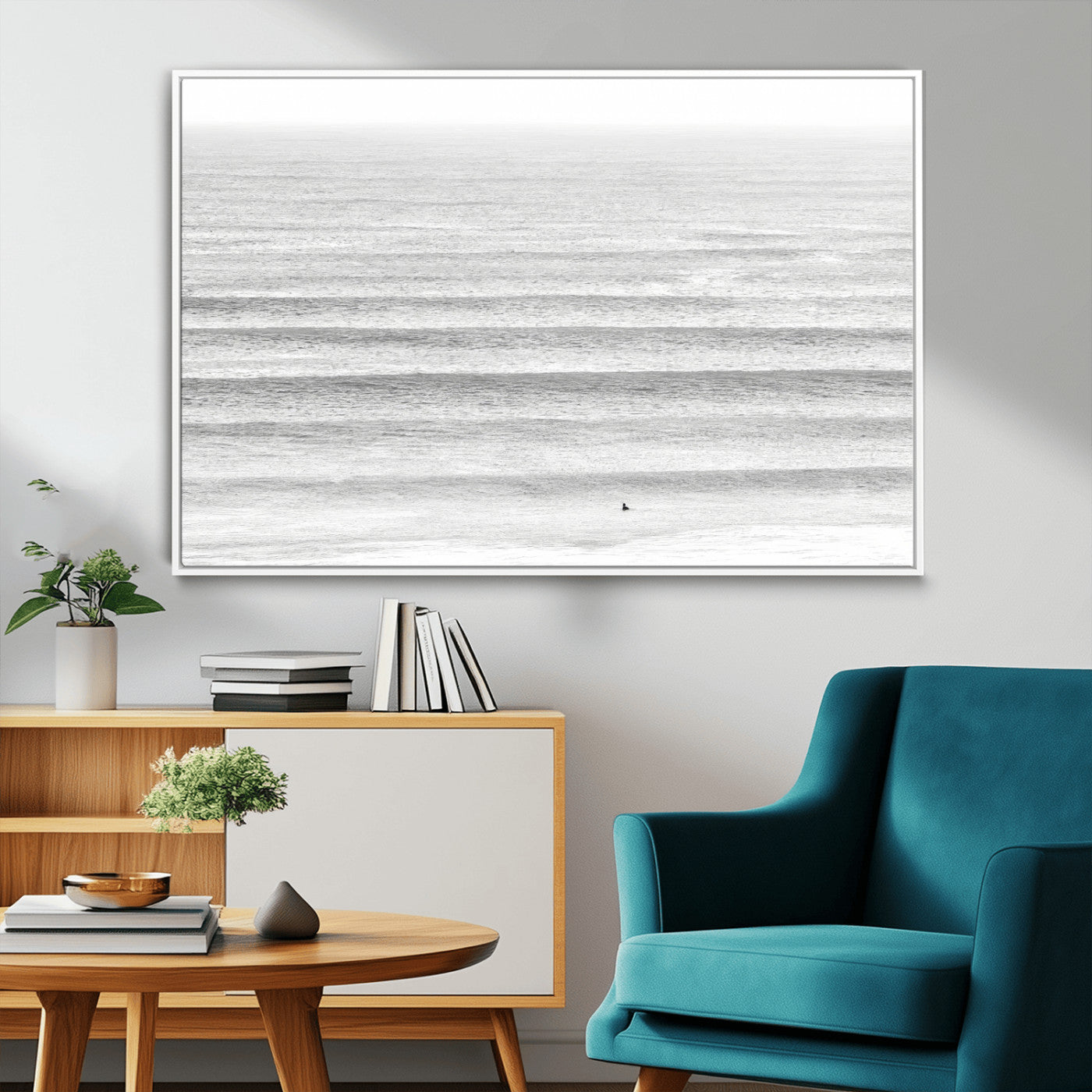 Monochrome photo of a lone surfer in calm layered waves, perfect for minimalist coastal or moody ocean-inspired wall decoration.