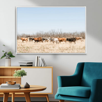 Framed wall art of Texas longhorn cattle walking through a dry, neutral-toned prairie, perfect for rustic farmhouse or western-themed home decor.