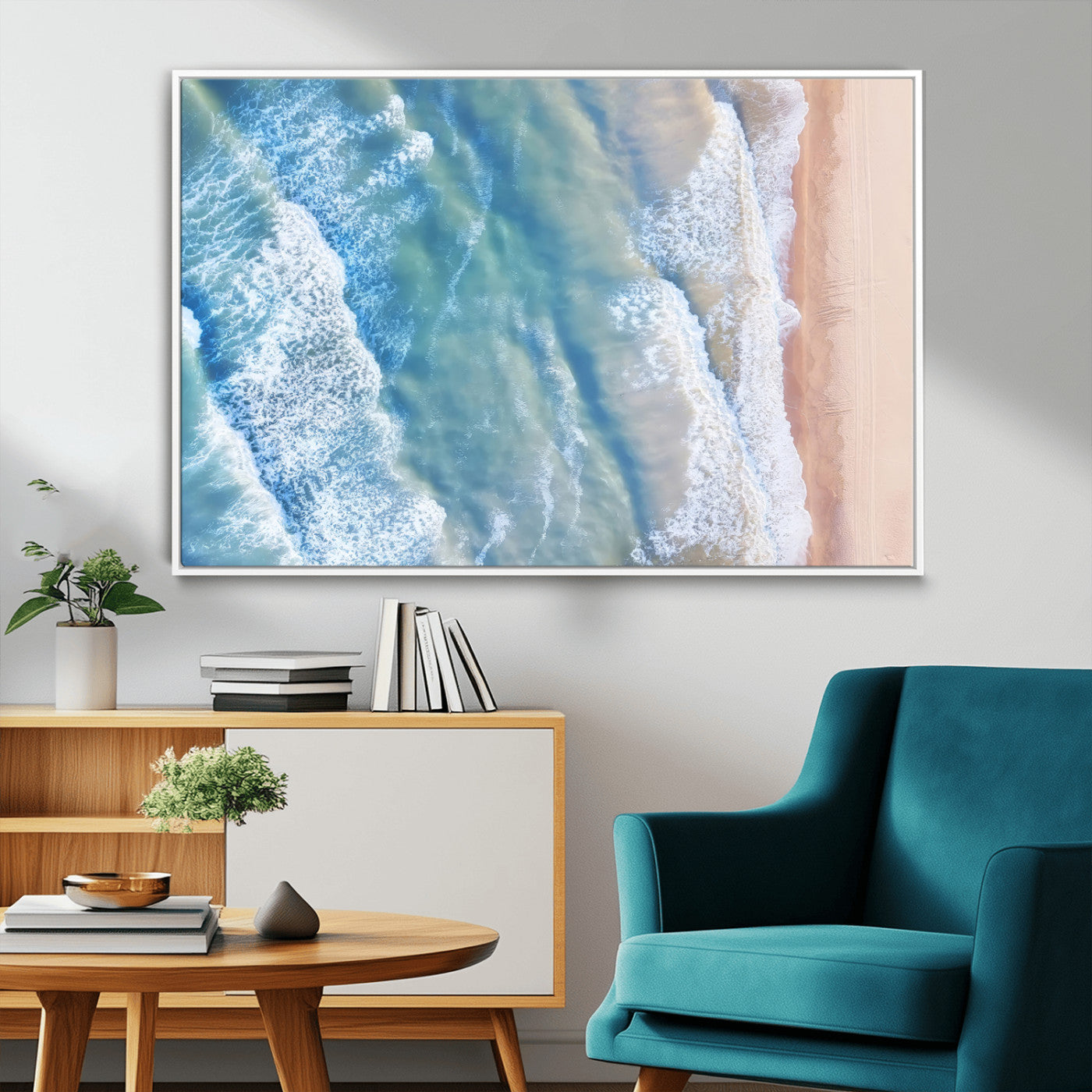 Aerial photo of soft blue waves meeting sandy shore, perfect for modern coastal or beach-themed decor with a light and tranquil aesthetic.