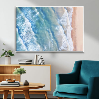 Aerial photo of soft blue waves meeting sandy shore, perfect for modern coastal or beach-themed decor with a light and tranquil aesthetic.
