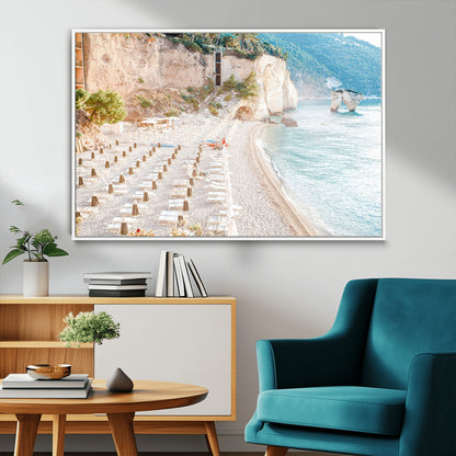 Wall art of a calm Mediterranean beach with rows of sun loungers and umbrellas in soft pastel tones, perfect for light coastal or vacation-themed decor.