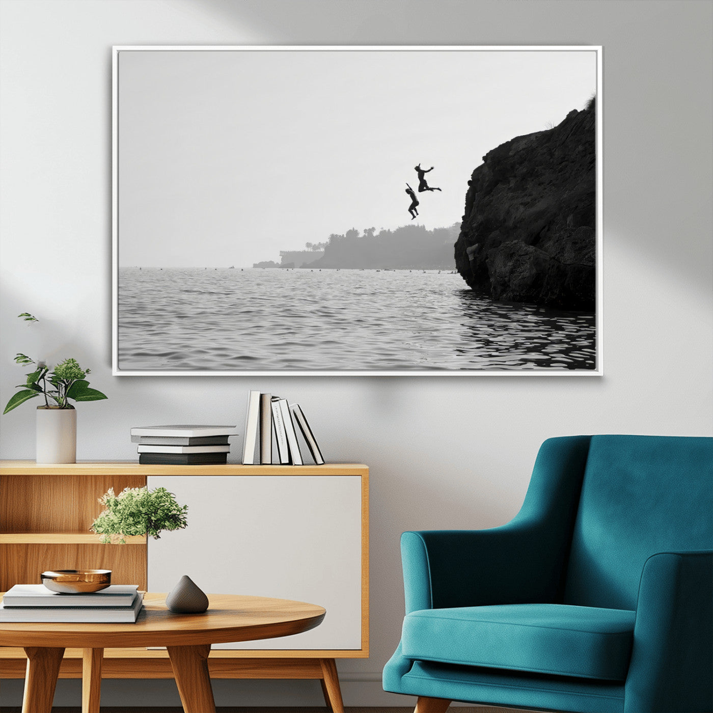 Black and white canvas of two figures cliff jumping into the sea, captured with moody tones, ideal for modern coastal or adventure-themed home decor.   2/2