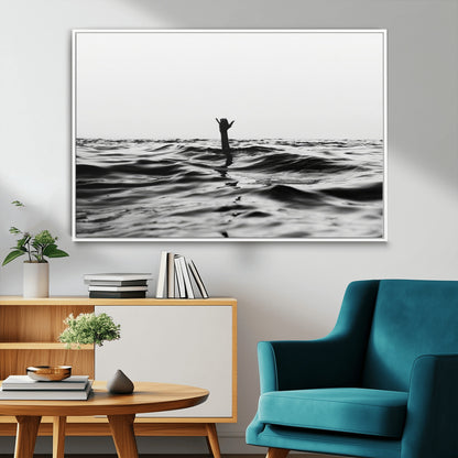 Black and white ocean with a hand making a surfer sign among dark waves, creating a dramatic and minimalist seascape with bold contrast.