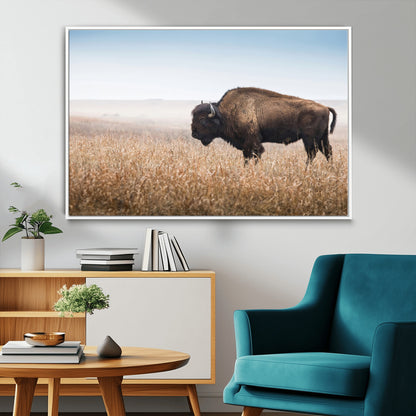 A majestic bison standing in an open prairie field, its strong form blending into the golden grass under a vast blue sky, evoking the wild spirit of the American plains.