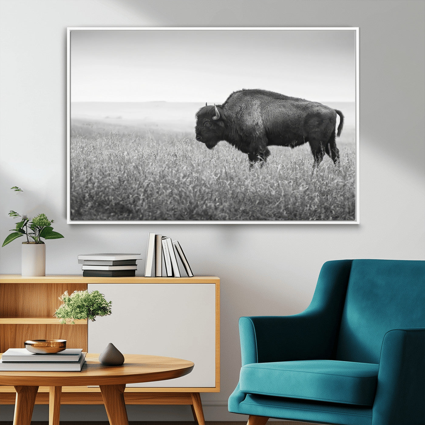 A black and white photograph of a majestic bison standing in a vast grassy prairie, evoking a sense of wilderness and strength.