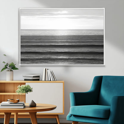 Minimalist black and white ocean view with layered waves reflecting sunlight, evoking a sense of calm and coastal serenity.