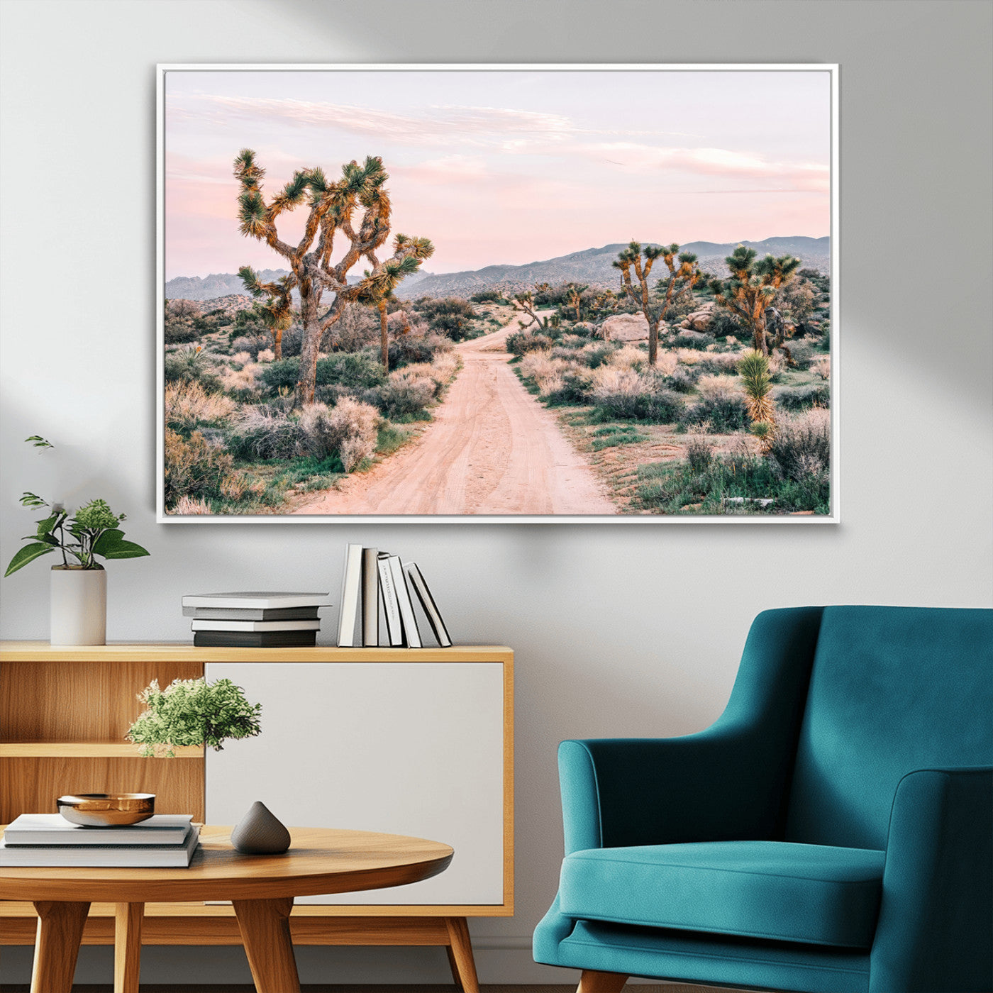 A dusty road winding through Joshua Tree National Park, framed by iconic twisted trees and warm desert tones under a soft pastel sky.