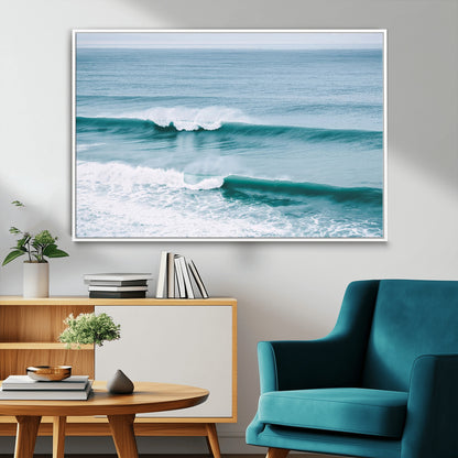 Powerful ocean waves rolling towards the shore, their turquoise hues blending with white sea foam under an open horizon, capturing the essence of the ocean's movement.