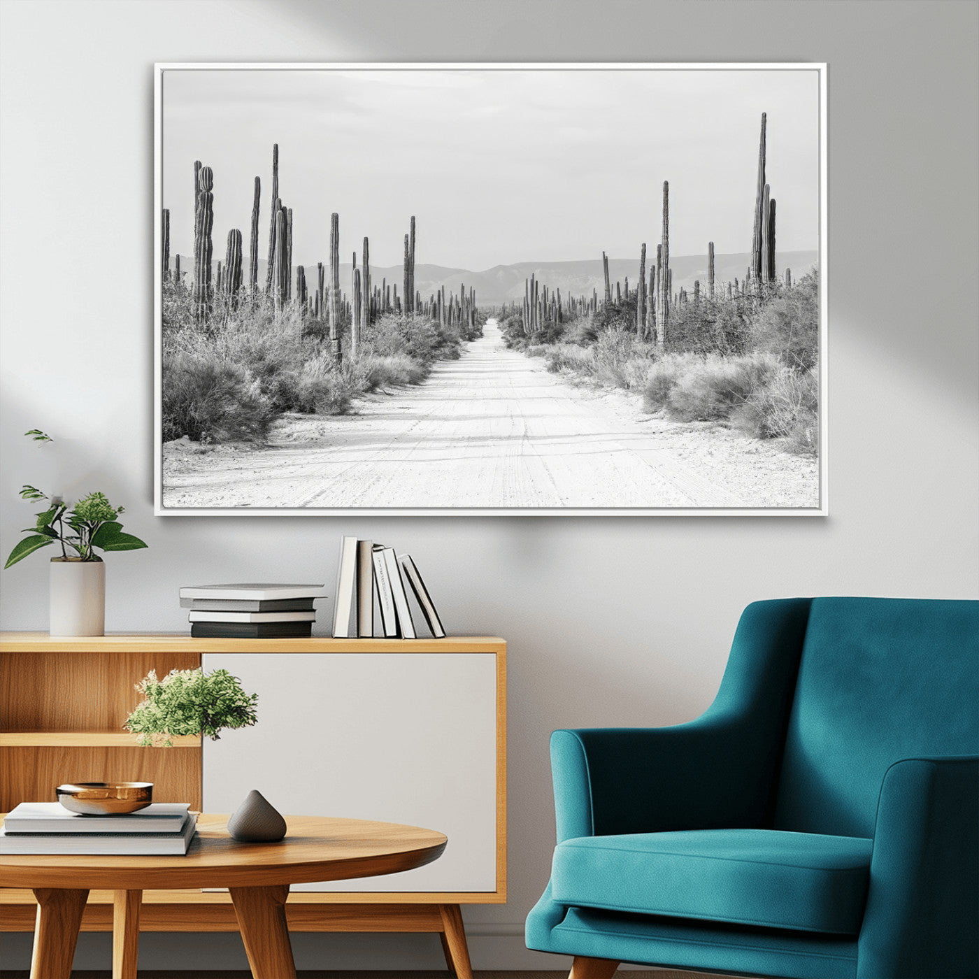 A black and white desert road stretching through a cactus-filled landscape, creating a rugged and timeless southwestern aesthetic with a sense of adventure.