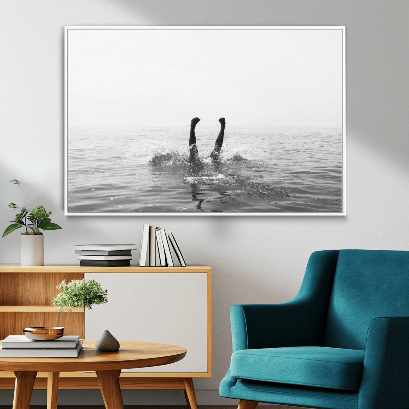 A black and white minimalist water scene capturing a playful splash as a swimmer dives upside down, creating a carefree and artistic aquatic aesthetic.