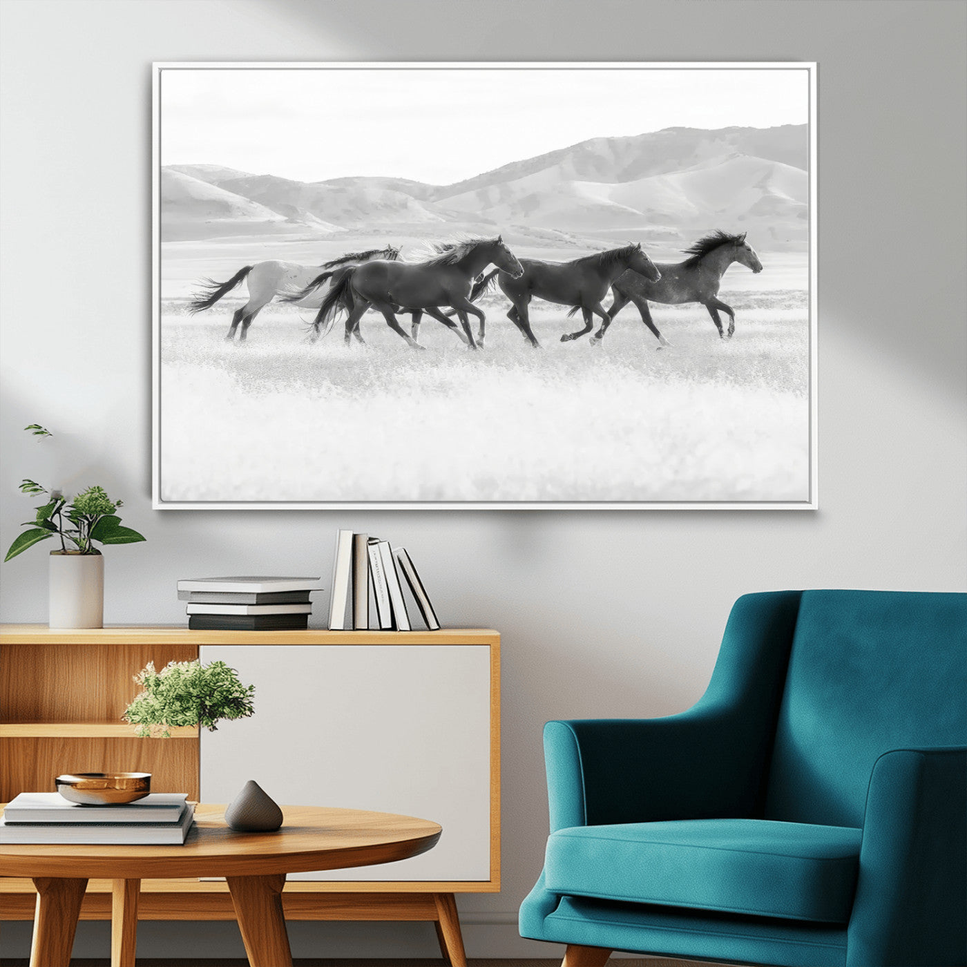 A black and white image of wild horses running freely across an open grassland, capturing the power and beauty of untamed nature in a rustic western setting.
