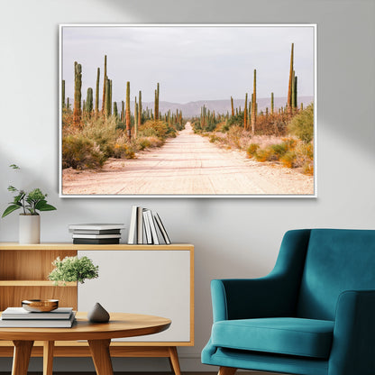 A desert road lined with saguaro cacti under a golden sky, creating a warm southwestern feel, perfect for boho or rustic decor.
