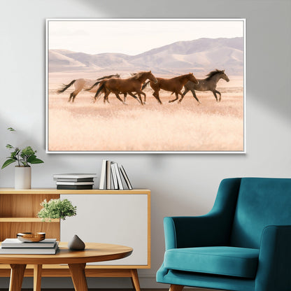 A herd of wild horses galloping through a sunlit desert plain with mountains in the background, perfect for rustic or western-themed wall decor.