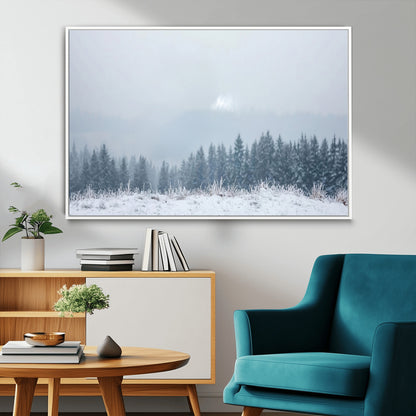 Snow-covered forest under misty sky, soft light breaking through clouds, ideal for minimalist or Nordic-inspired home decor.
