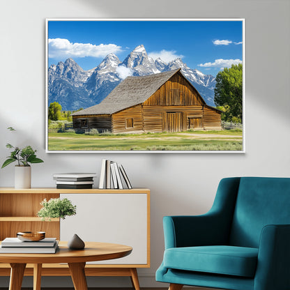 A rustic wooden barn sits in front of towering mountain peaks under a clear blue sky, perfect for farmhouse or cabin style interiors.