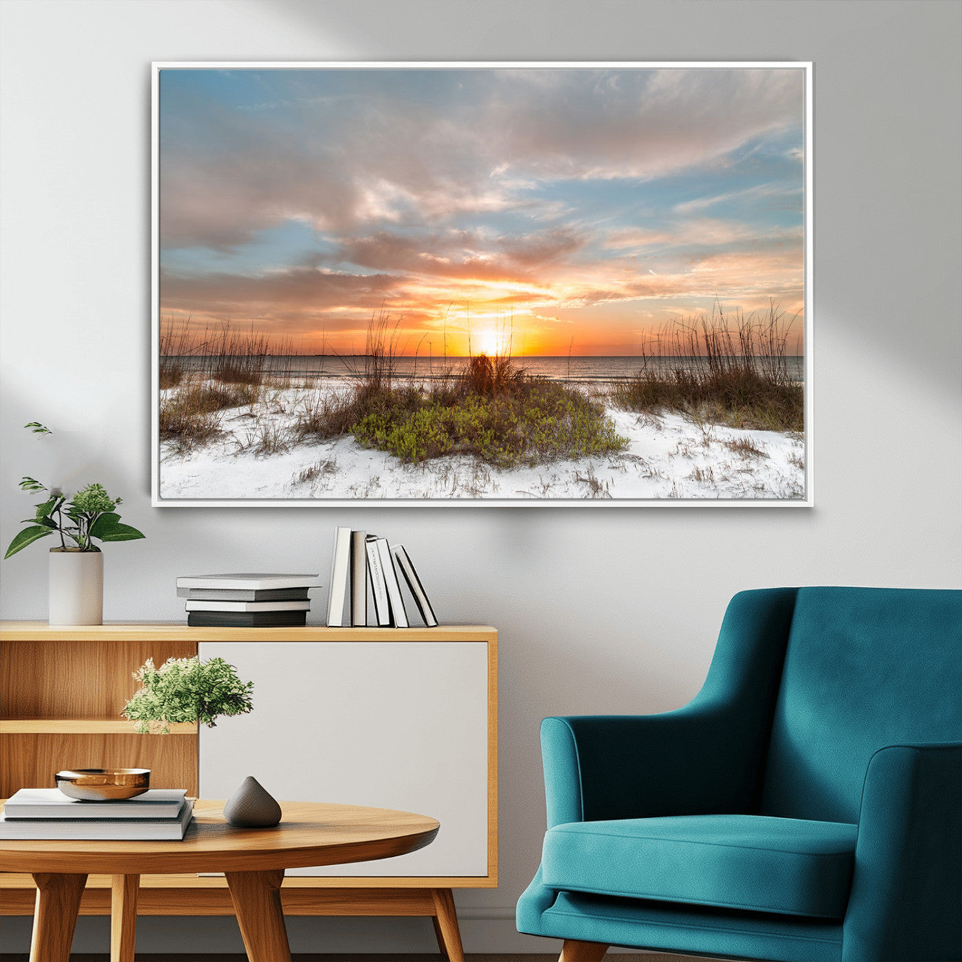 A tranquil beach scene featuring golden sunset hues over the water, with grasses in the foreground and a peaceful, serene atmosphere.