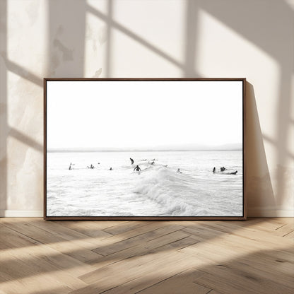 Monochrome photo of surfers riding and waiting on ocean waves, ideal for surf-themed or coastal energy wall decor.