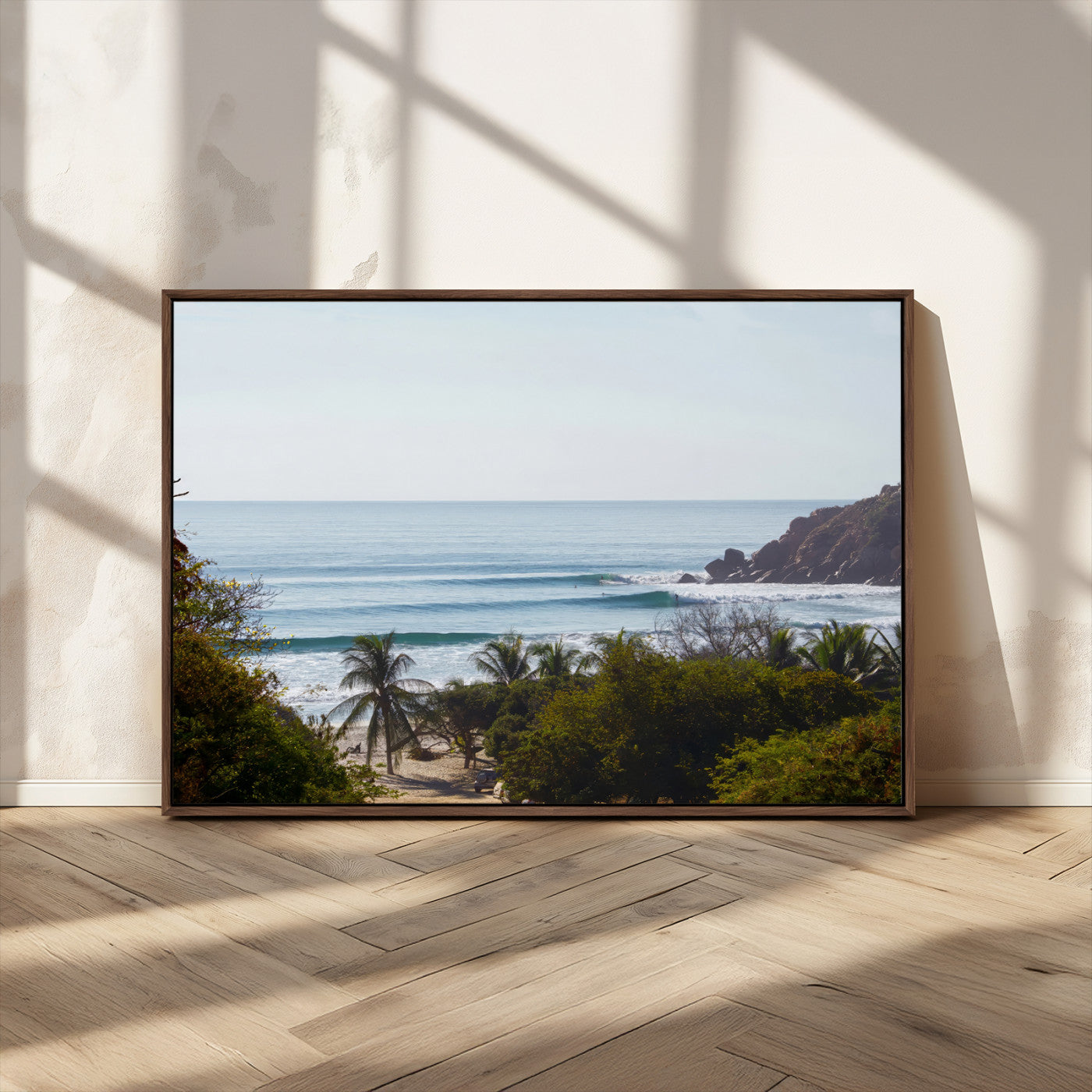 View of calm ocean waves with palm trees and a tropical coastline, ideal for coastal boho or beach-themed wall decor.