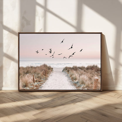 A peaceful coastal pathway leading to the ocean, with birds flying across a soft pastel sky, creating a calm and scenic beach atmosphere.