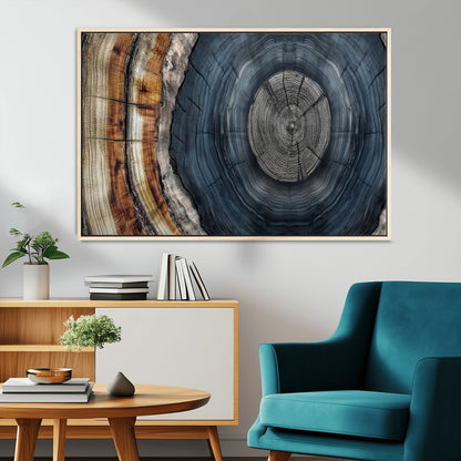 A stunning close-up of a tree trunk showing the intricate, circular growth rings, showcasing the natural textures and rich contrasts in deep blues, browns, and silvers.