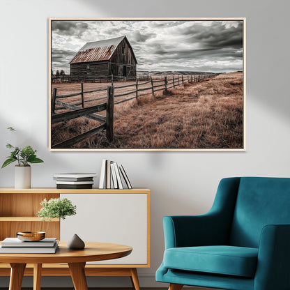 Framed canvas of a rustic barn under a moody sky with weathered fence and dark fields, ideal for farmhouse or rural-style wall decor.