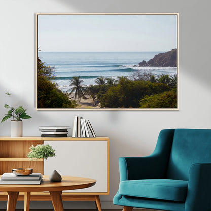 View of calm ocean waves with palm trees and a tropical coastline, ideal for coastal boho or beach-themed wall decor.