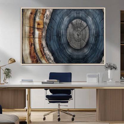 A stunning close-up of a tree trunk showing the intricate, circular growth rings, showcasing the natural textures and rich contrasts in deep blues, browns, and silvers.