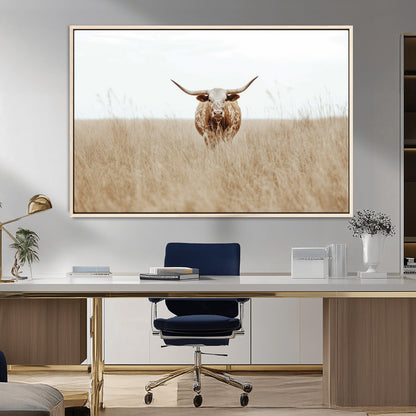 Texas Longhorn bull standing alone in dry grass with neutral tones, ideal for rustic western or cowboy-themed wall decor.