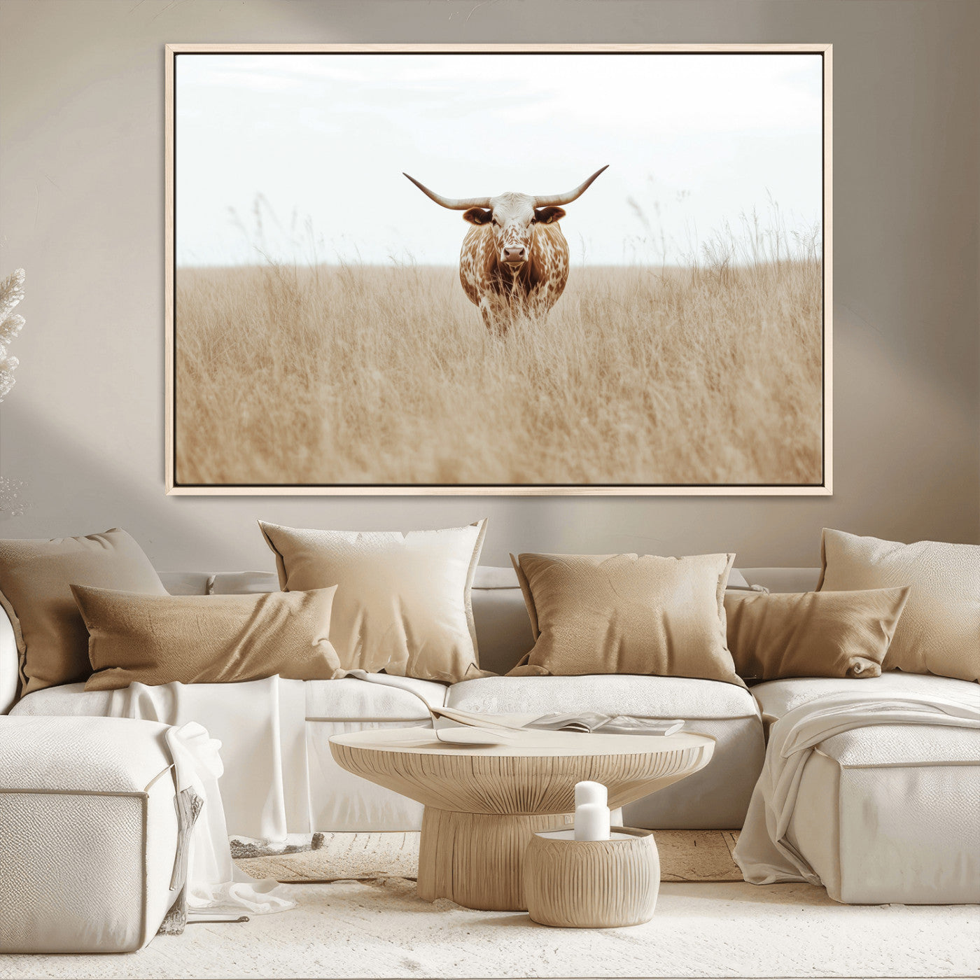 Texas Longhorn bull standing alone in dry grass with neutral tones, ideal for rustic western or cowboy-themed wall decor.