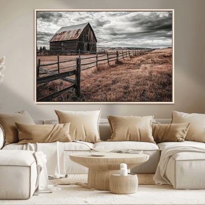 Framed canvas of a rustic barn under a moody sky with weathered fence and dark fields, ideal for farmhouse or rural-style wall decor.