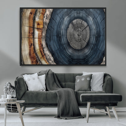 A stunning close-up of a tree trunk showing the intricate, circular growth rings, showcasing the natural textures and rich contrasts in deep blues, browns, and silvers.