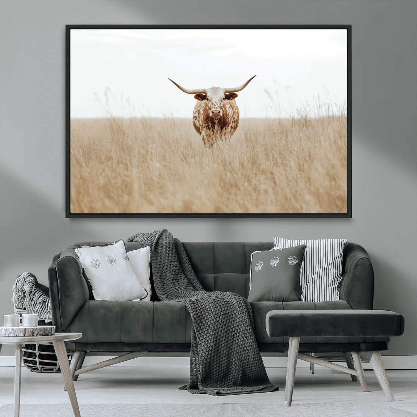 Texas Longhorn bull standing alone in dry grass with neutral tones, ideal for rustic western or cowboy-themed wall decor.