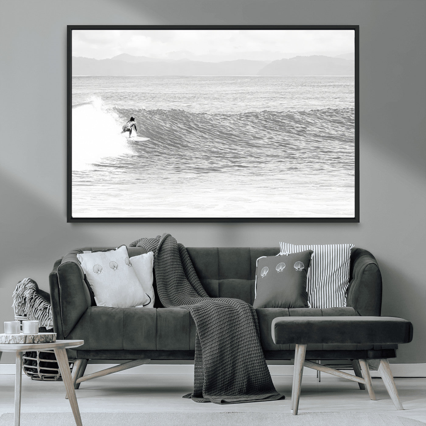 Monochrome photo of a surfer riding a wave with distant mountains, ideal for coastal motion or black and white surf-themed wall decor.