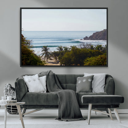 View of calm ocean waves with palm trees and a tropical coastline, ideal for coastal boho or beach-themed wall decor.