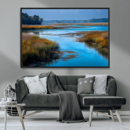 A peaceful marshland scene with calm blue water reflecting the surrounding grasses and trees, capturing the beauty of nature in a serene landscape.