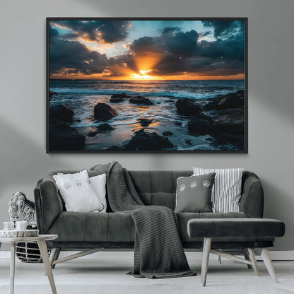 An awe-inspiring sunset over the ocean with rays of light piercing through dramatic clouds, creating a beautiful seascape with rocks in the foreground.