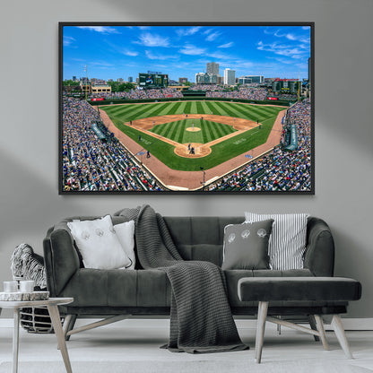 A wide-angle shot of a baseball field filled with spectators, with players on the field and the iconic Wrigley Field scoreboard in the background.