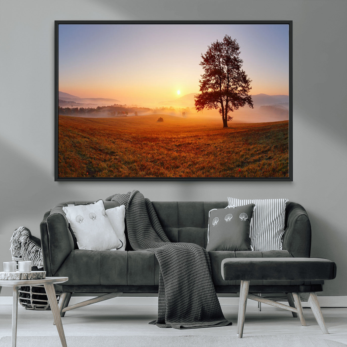 A tranquil landscape at sunrise with a mist-covered field and a lone tree, creating a peaceful and natural atmosphere.