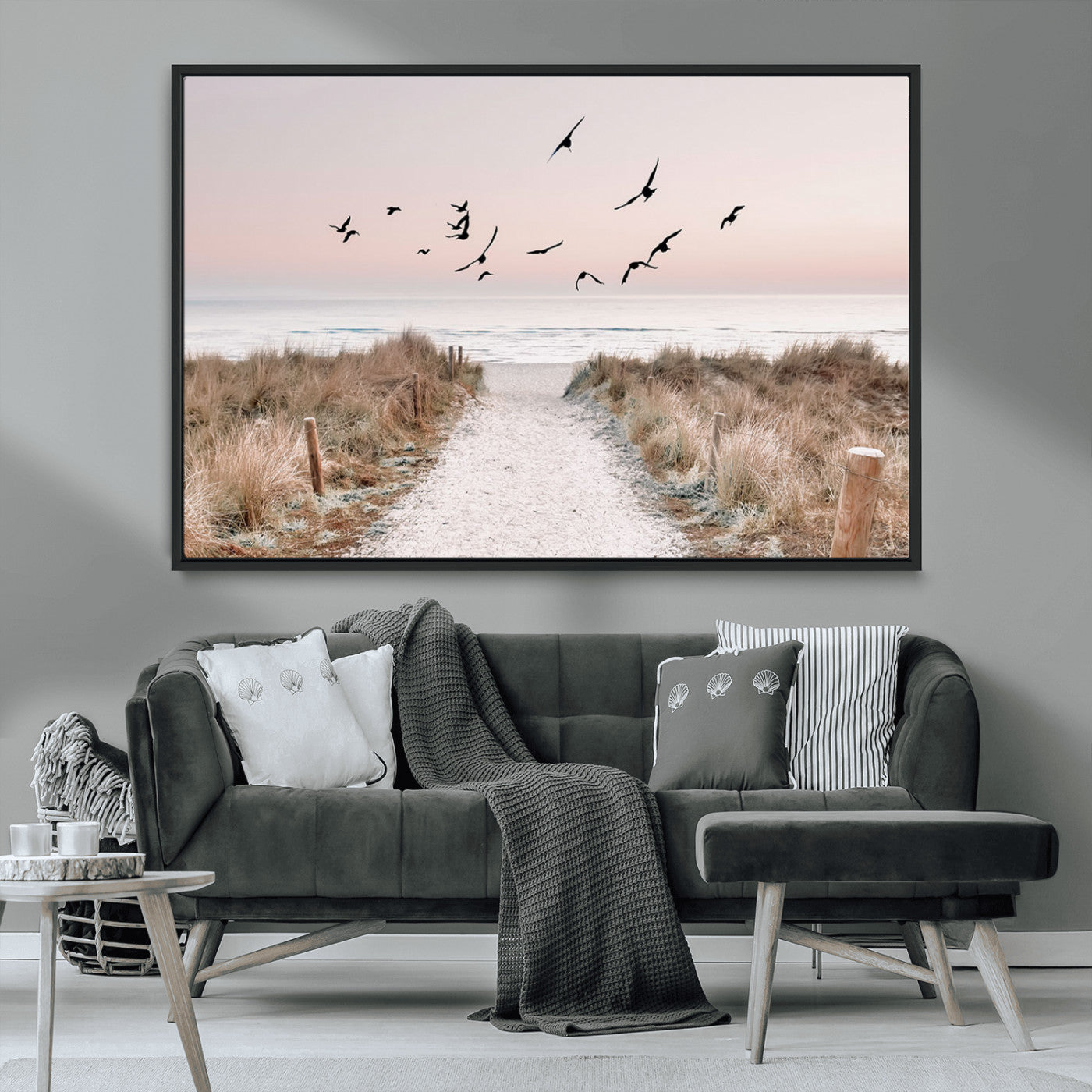 A peaceful coastal pathway leading to the ocean, with birds flying across a soft pastel sky, creating a calm and scenic beach atmosphere.