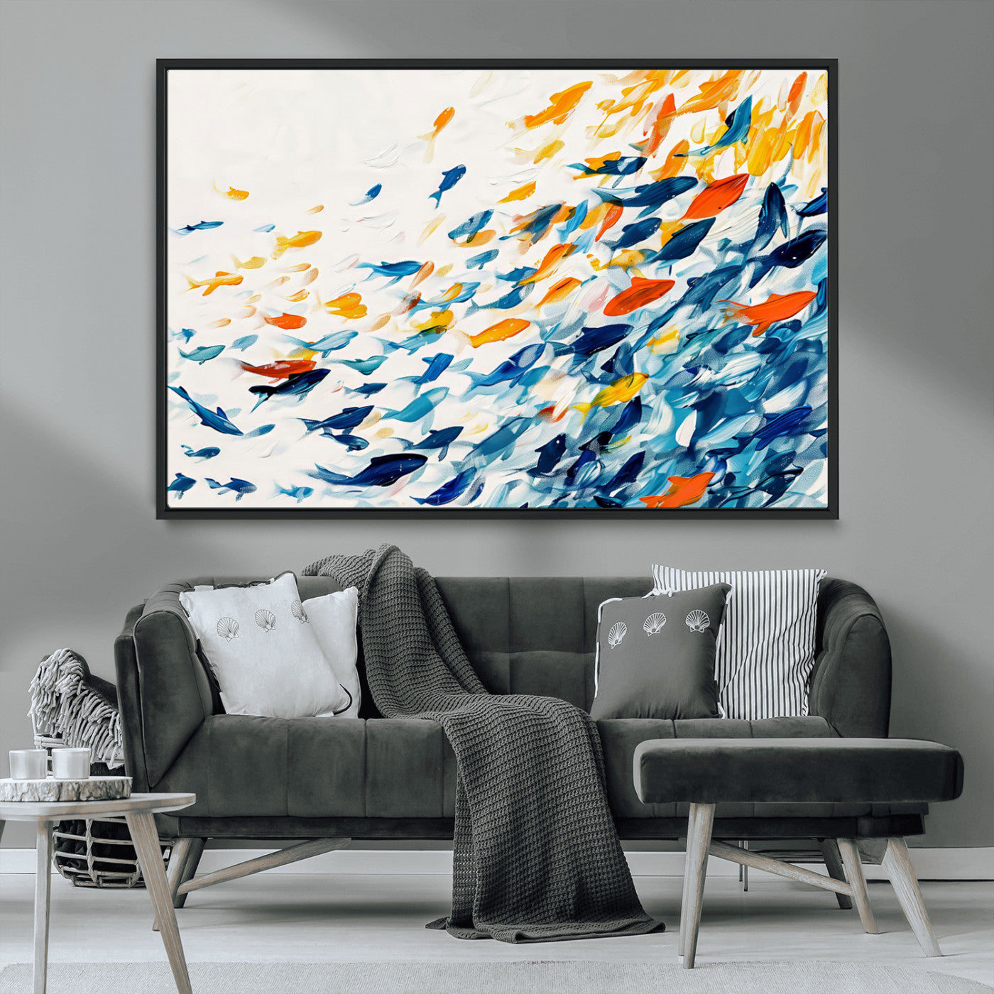A modern abstract canvas featuring a dynamic school of colorful fish in blue, orange, and yellow tones, ideal for coastal or contemporary decor.