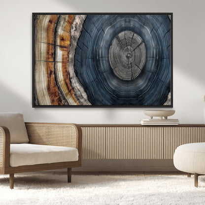 A stunning close-up of a tree trunk showing the intricate, circular growth rings, showcasing the natural textures and rich contrasts in deep blues, browns, and silvers.