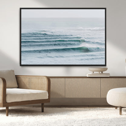 High-angle view of surfers lining up across layered ocean waves, ideal for minimal coastal or surf-inspired room decor.