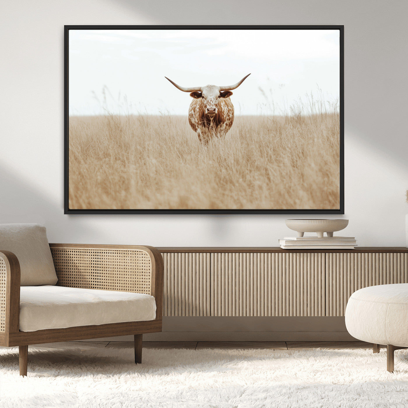 Texas Longhorn bull standing alone in dry grass with neutral tones, ideal for rustic western or cowboy-themed wall decor.