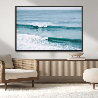 Powerful ocean waves rolling towards the shore, their turquoise hues blending with white sea foam under an open horizon, capturing the essence of the ocean's movement.