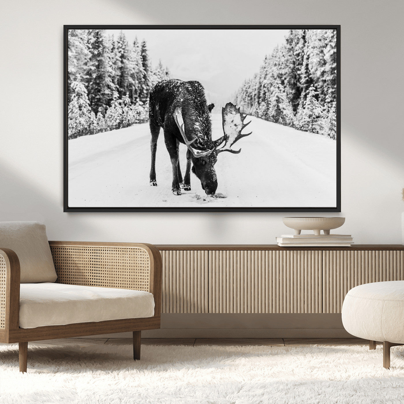 A majestic moose grazing in the snow-covered wilderness, surrounded by snow-covered trees, creating a peaceful winter scene.