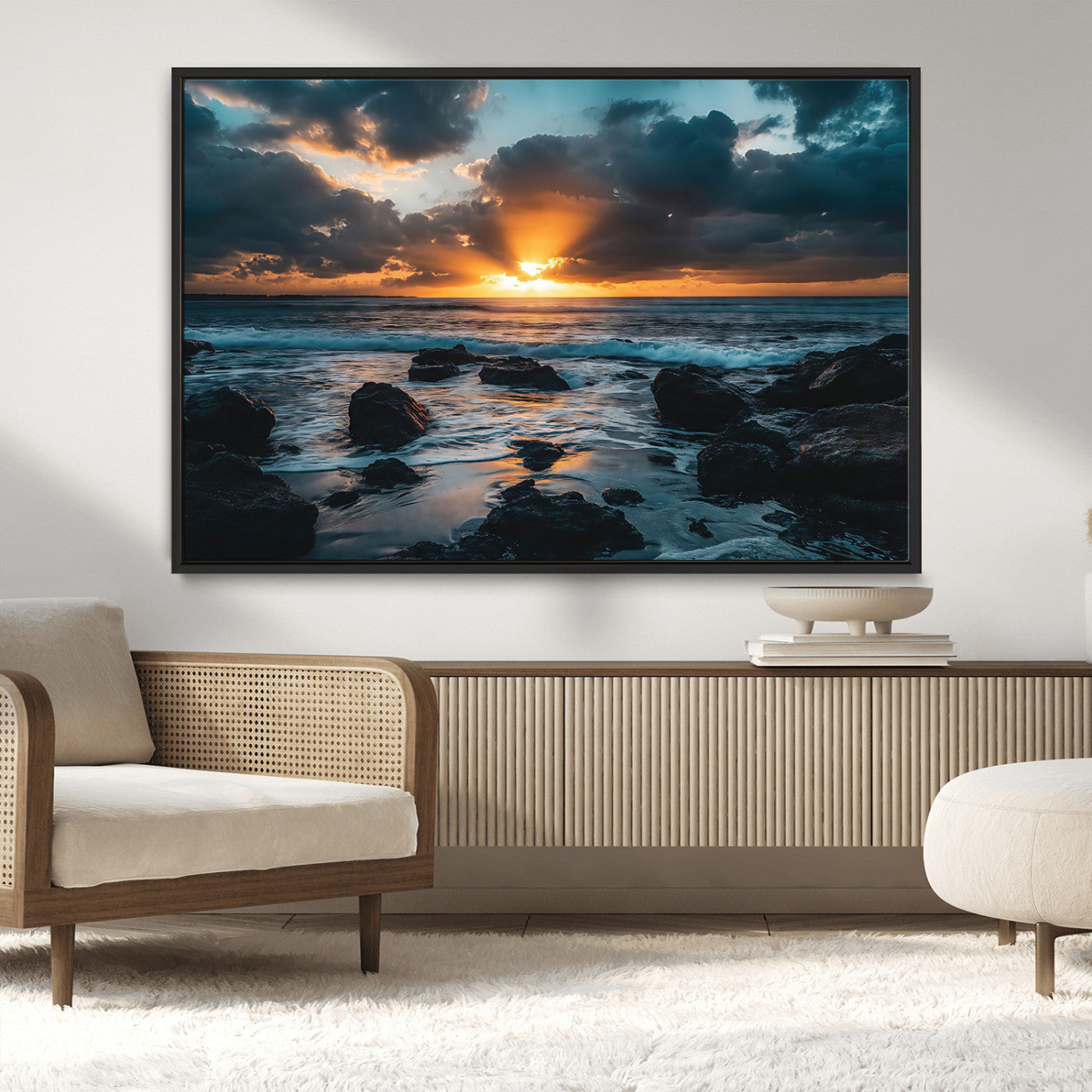 An awe-inspiring sunset over the ocean with rays of light piercing through dramatic clouds, creating a beautiful seascape with rocks in the foreground.