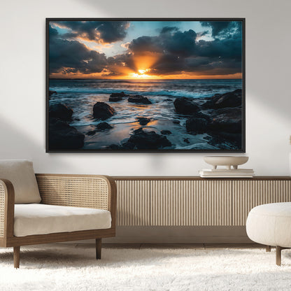 An awe-inspiring sunset over the ocean with rays of light piercing through dramatic clouds, creating a beautiful seascape with rocks in the foreground.